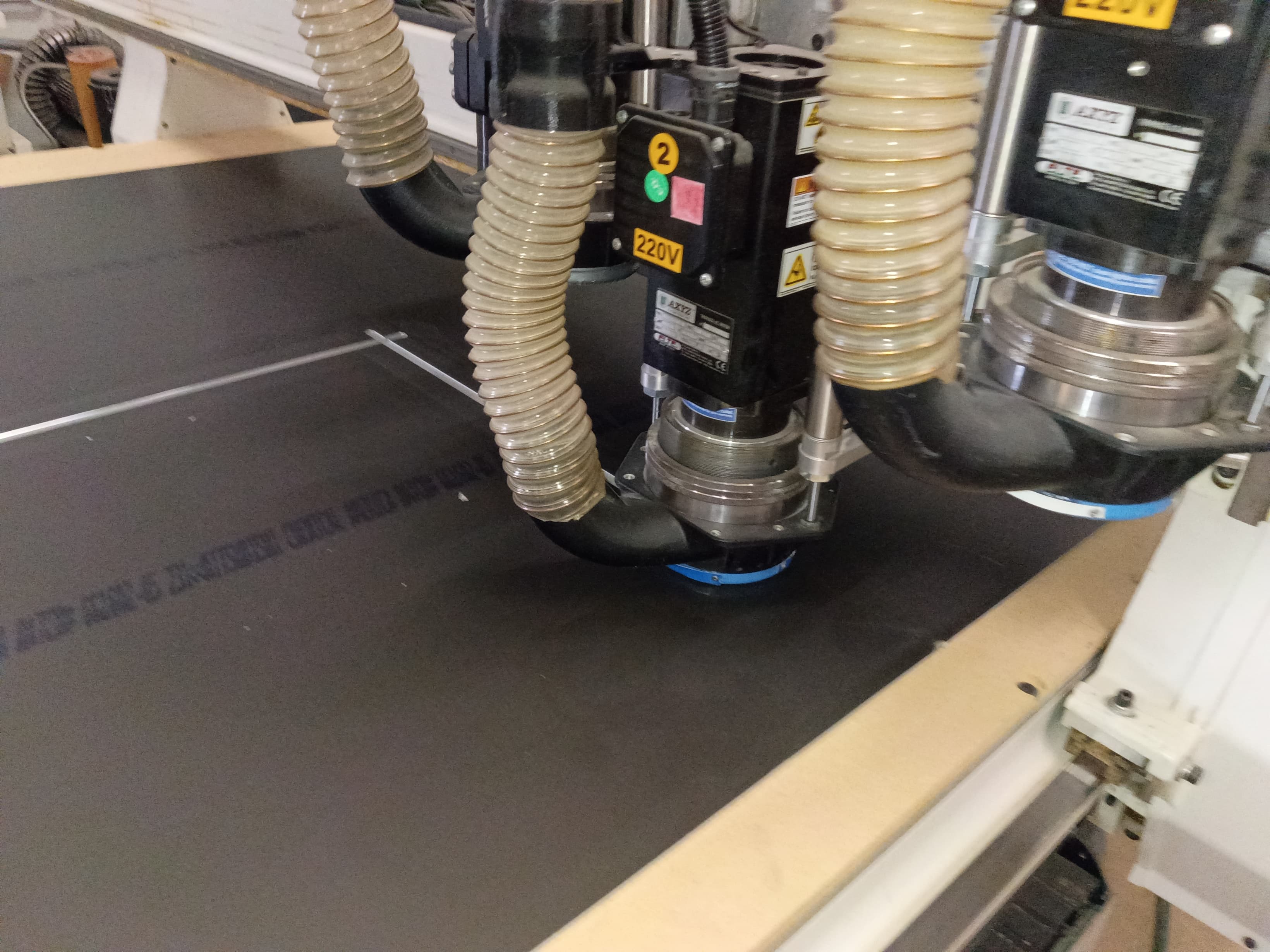 Close-up of precision ACM routing on an AXYZ CNC machine