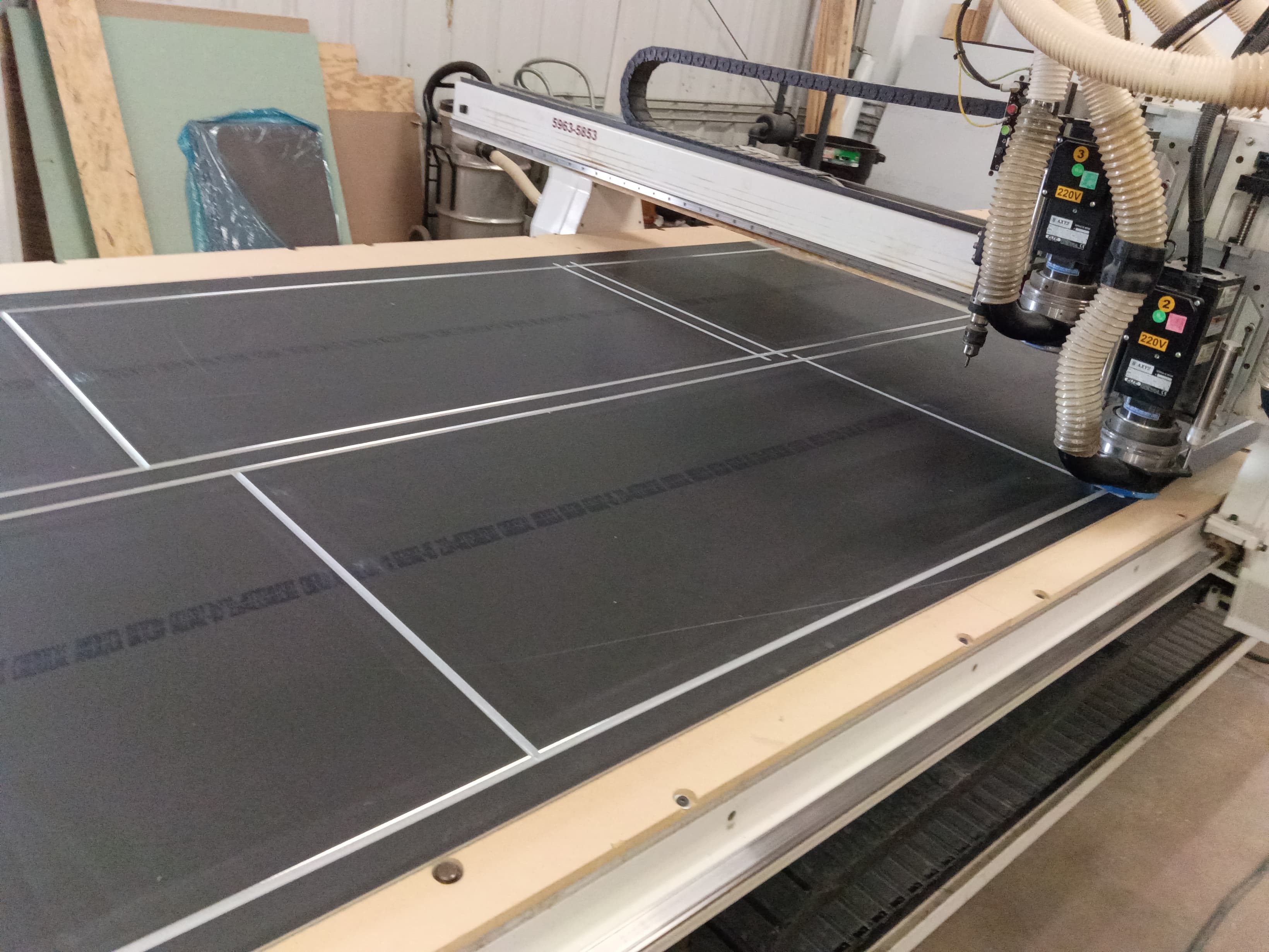 ACM sheet being CNC routed on the Kansas Architectural Metals AXYZ machine